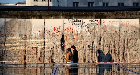 Couple walking by Wall