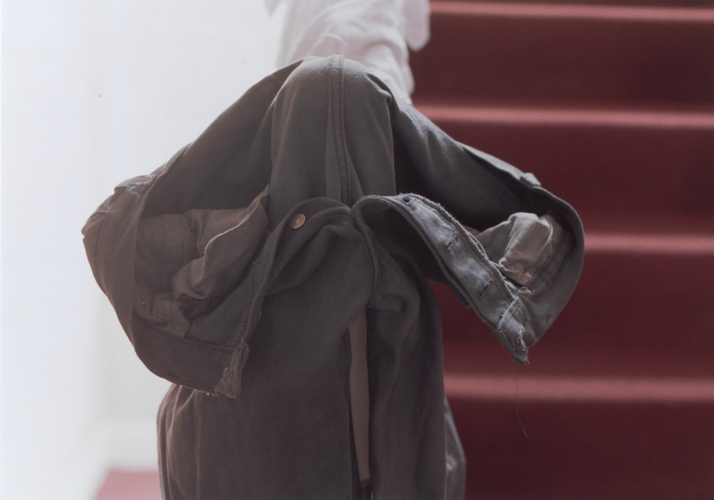 grey jeans over stair post