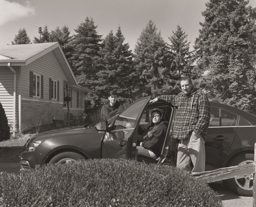 Jonathan Auckey, Jr., UAW Local 1112, with his wife and son, Monique and Michael, and the rainforest green, Chevrolet Cruze compact sedan he built and purchased for Monique, (19.5 years in at GM Lord-stown Complex, body shop), Austintown, OH.