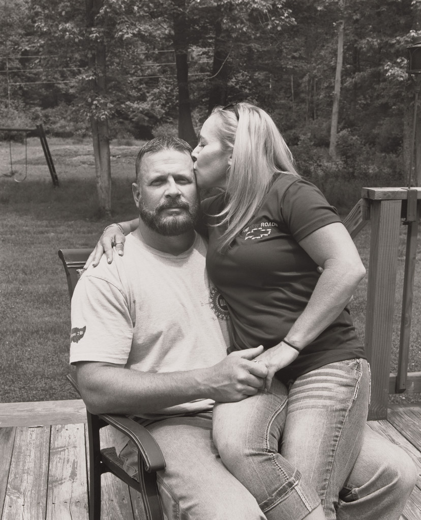 Tawnya Morgan, UAW Local 1112, kissing her husband Dan on their back deck, (23 years in at GM Lordstown Complex, trim shop, door line team leader), Hartford, OH