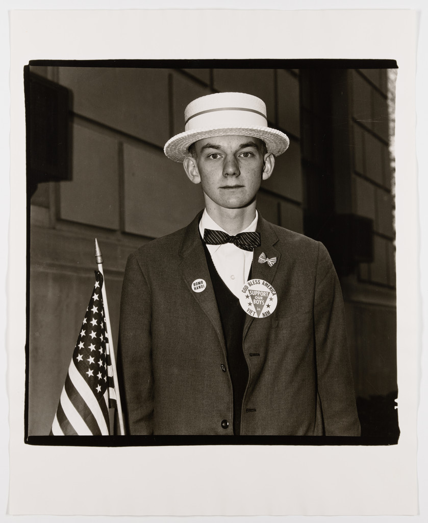 Boy with a straw hat waiting to march in a pro-war parade, N.Y.C., 1967