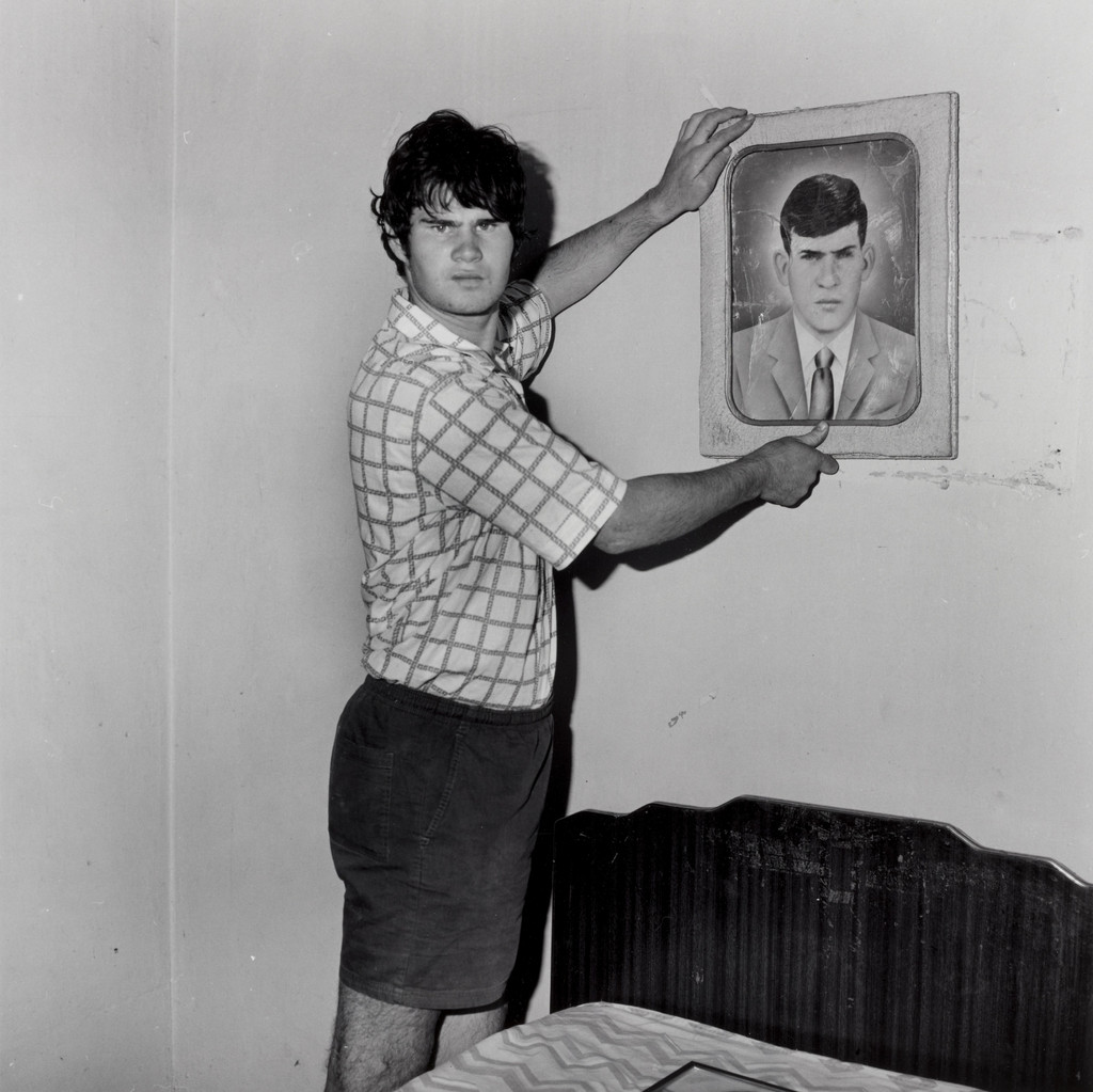 Factory Worker Holding Portrait of Grandfather