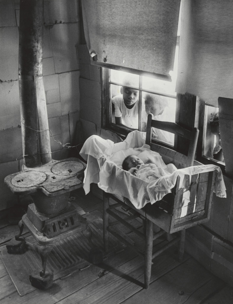 Newborn Baby in Makeshift Crib near Cold Stove
