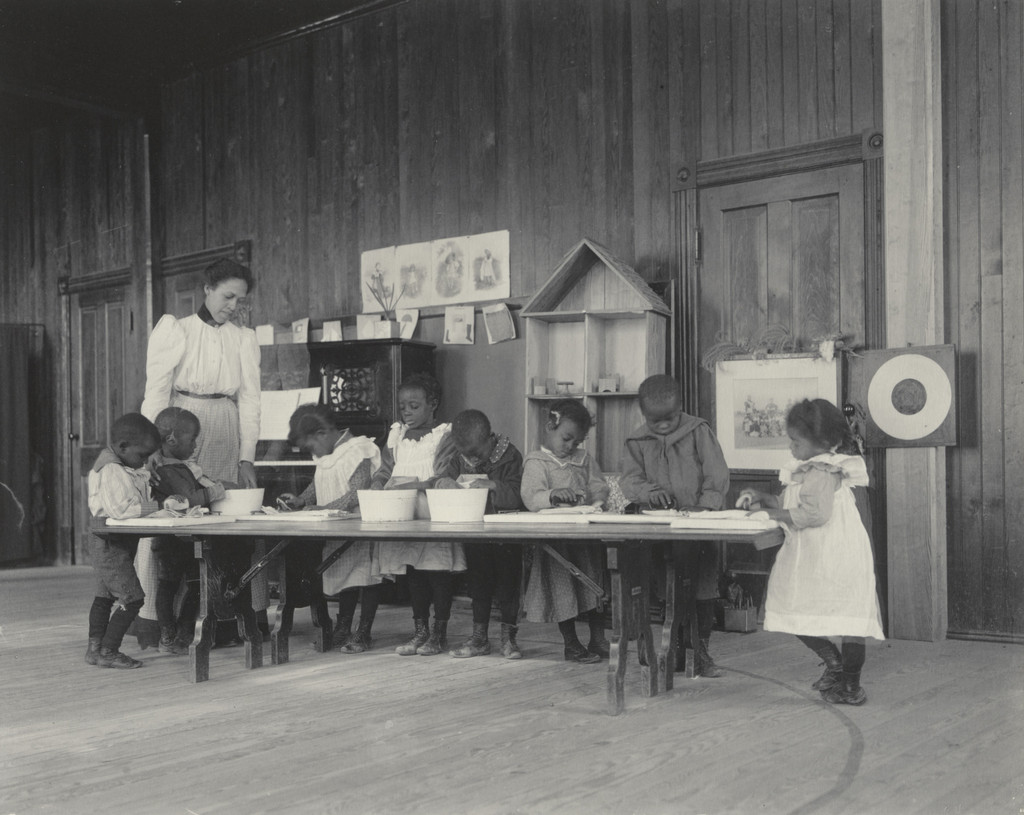 Kindergarten children washing and ironing