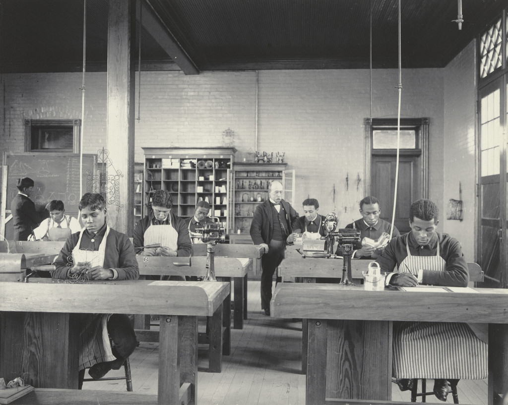 A class in manual training. Bent iron and tin